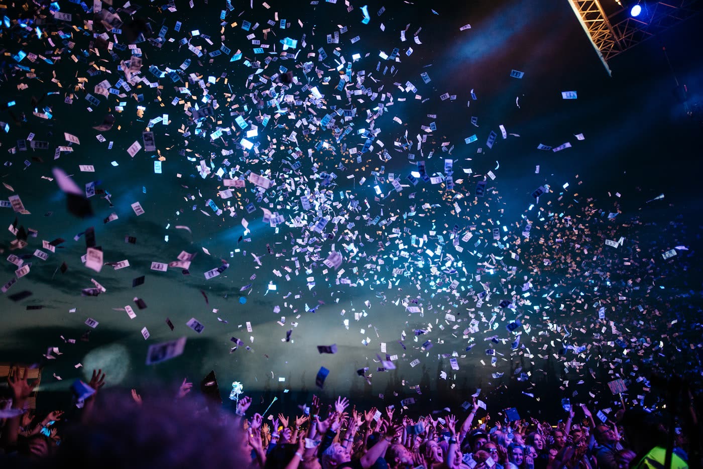 Confetti falling over a celebrating crowd at night