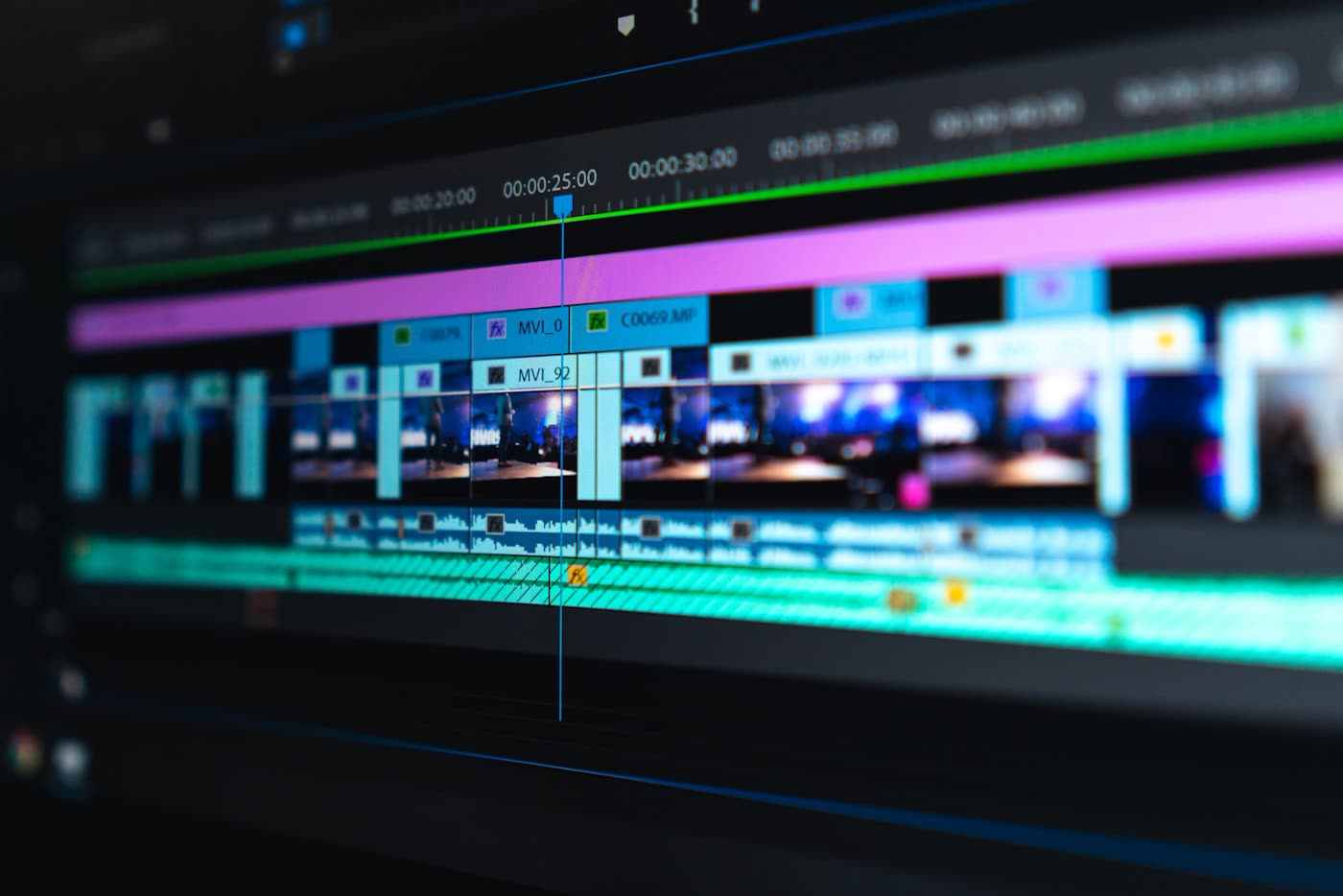 Close-up of a video editing timeline with colour-coded tracks