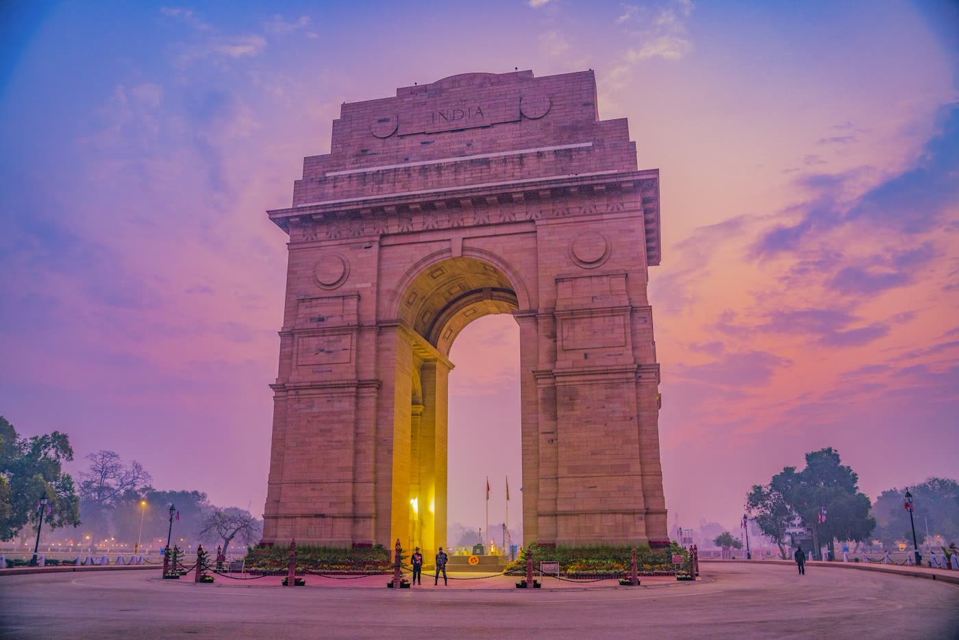 India Gate in Delhi at dusk under a purple sky